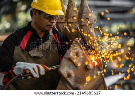 Industrial worker metal cutting with acetylene torch at factory welding steel structure, Welder is welding metalwork manufacturing construction maintenance service. Royalty-Free Stock Photo #2149685617
