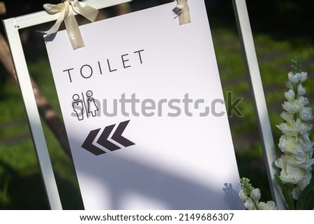 bathroom sign with light and shadow