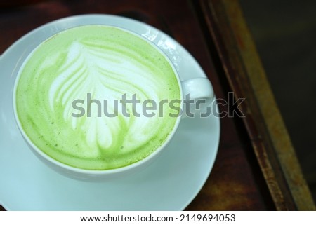 hot green tea on wooden floor	