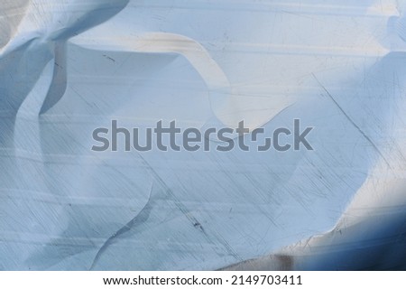 Bent sheet of metal with scratches, background