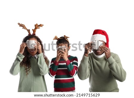 African-American family with Christmas decor and tasty hot chocolate on white background