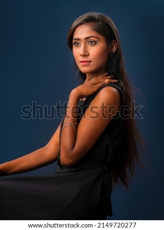 Portrait of a young beautiful girl posing on gray background