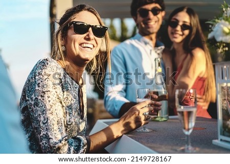 Happy friends gathering at terrace party having fun and drinking sparkling white wine - life style concept of young people hangout on weekend talking and consuming alcoholic drinks Royalty-Free Stock Photo #2149728167