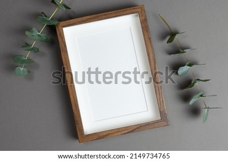 Frame mockup for artwork, photo or print presentation with eucalyptus twigs