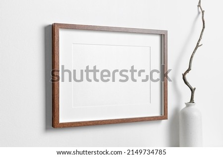 Landscape frame mockup on white wall for artwork, photo, painting or print presentation, blank frame with copy space
