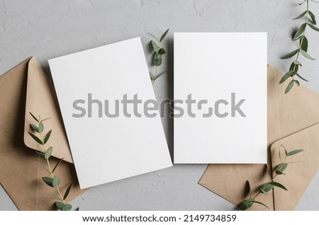 Iinvitation card mockup with envelopes and eucalyptus twigs, front and back sides