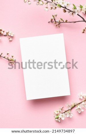 Greeting or invitation card mockup with flowers on pink background