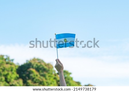 hand holding Argentina flag on nature background. 9th July of Independence day, 25th May of Revolution day and happy celebration concepts Royalty-Free Stock Photo #2149738179