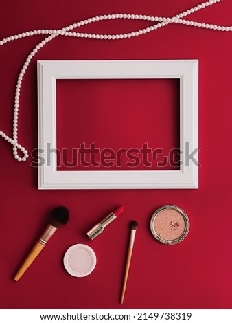 White horizontal art frame, make-up products and pearl jewellery on red background as flatlay design, artwork print or photo album concept