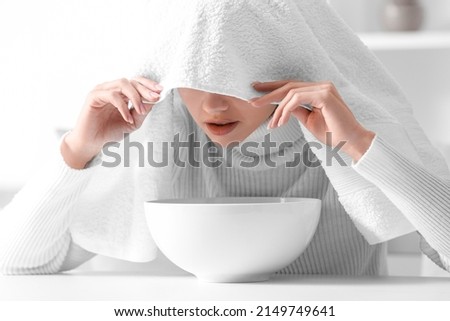 Young woman doing steam inhalation at home to soothe and open nasal passages Royalty-Free Stock Photo #2149749641