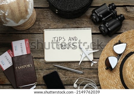 Flat lay composition with notebook on wooden table. Tips and Tricks