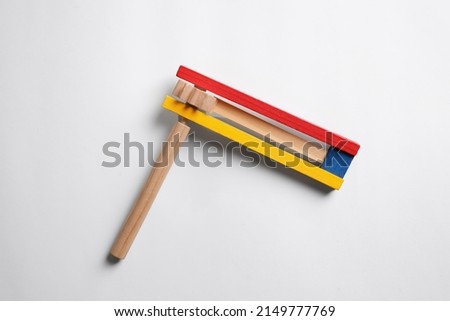 Wooden spinning ratchet isolated on white, top view. Montessori musical toy Royalty-Free Stock Photo #2149777769