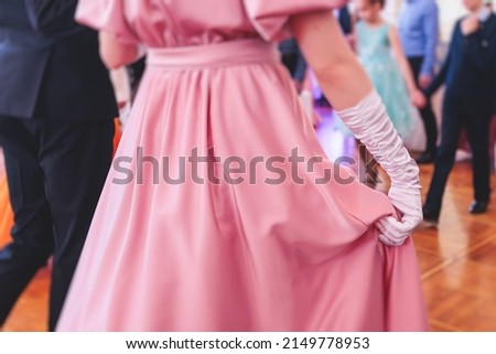 Couples dance on the historical costumed ball in historical dresses, classical ballroom dancers dancing, waltz, quadrille and polonaise in palace interiors on a wooden floor, charity event Royalty-Free Stock Photo #2149778953