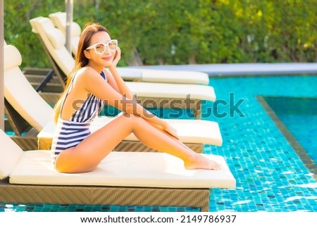 Portrait beautiful young asian woman relax smile leisure on vacation around swimming pool in resort hotel Royalty-Free Stock Photo #2149786937