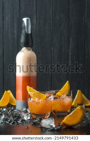 Orange juice in a bottle. Photo of food on a dark background