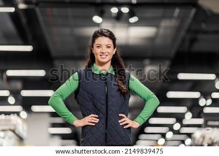 A successful manager standing at the supermarket and smiling at the camera. Royalty-Free Stock Photo #2149839475