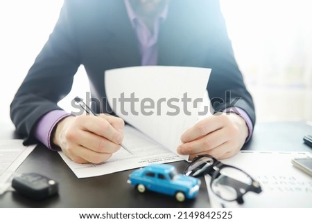 The insurance agent signs a document. Car insurance policy. Auto insurance policy. Forms registration of the contract. Royalty-Free Stock Photo #2149842525