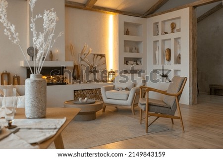 cozy warm home interior of a chic country house with an open plan, wood finishes, warm colors and a family hearth. view of the recreation area for family and guests Royalty-Free Stock Photo #2149843159