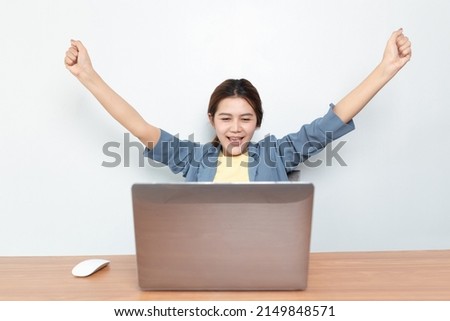 business woman  in casual clothes using laptop and smiling while working at home