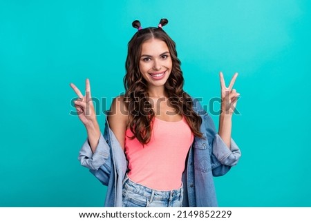 Photo of young cheerful girl show fingers peace victory v-symbol vacation isolated over turquoise color background