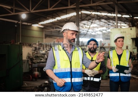 Professional Caucasian manager engineer in safety uniform is training industry factory worker, workshop factory operator, mechanical engineering team production in heavy industrial manufacture factory Royalty-Free Stock Photo #2149852477