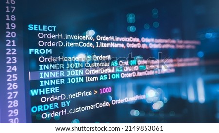 SQL (Structured Query Language) code on computer monitor and server room background. Example of SQL code to query data from a database.  Royalty-Free Stock Photo #2149853061