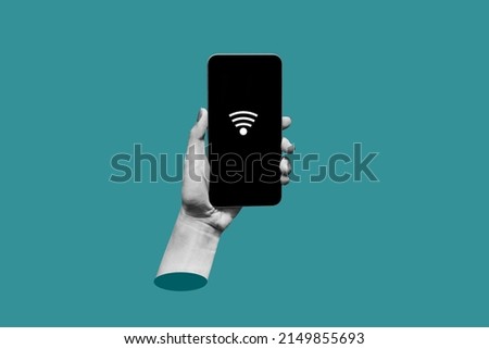 Mobile phone with black screen and Wi-Fi icon in female hand on a teal blue color background. Trendy collage in magazine style. Contemporary art. Modern design.  3d mockup of smartphone Royalty-Free Stock Photo #2149855693