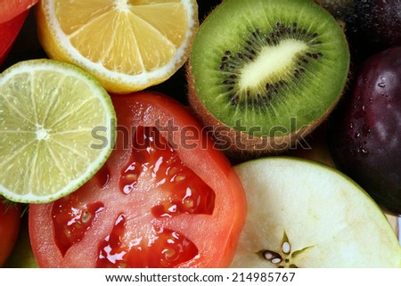 close-up of assorted cut ripe fruits and vegetables studio