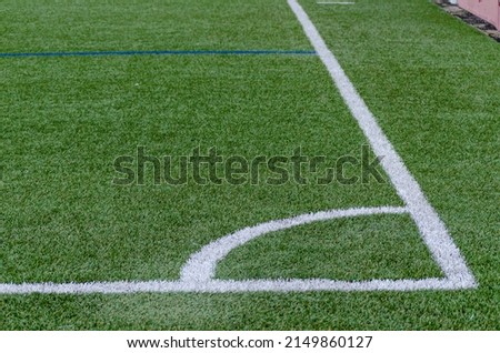 Corner line of a blue artificial turf football field