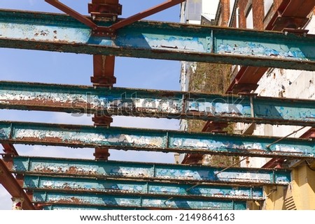 Abstract view of old steel girders, looking upwards to old steel construction. Royalty-Free Stock Photo #2149864163