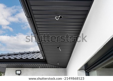 A modern graphite roof lining is attached to the trusses, visible cables and holes for LED lights. Royalty-Free Stock Photo #2149868523