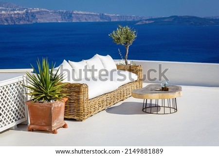 A sun terrace with sofa in Thira, Santorini island, Greece. Beautiful rest place over the caldera.