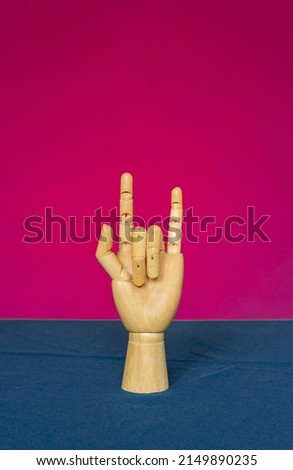 Wooden hand with two protruding fingers