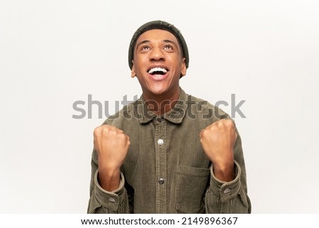 Extremely excited overjoyed man shouting making yes gesture, amazed with his victory, triumph. Indoor studio shot isolated on white background Royalty-Free Stock Photo #2149896367