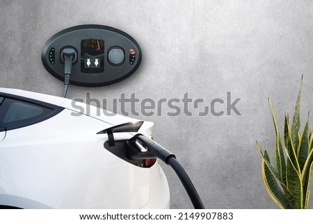 Home garage charging electric vehicle with cable  EV Tesla Royalty-Free Stock Photo #2149907883