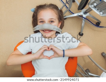 little girl with sedation mask. Treatment of children's teeth with nitrous oxide. children's dentistry. Royalty-Free Stock Photo #2149924071