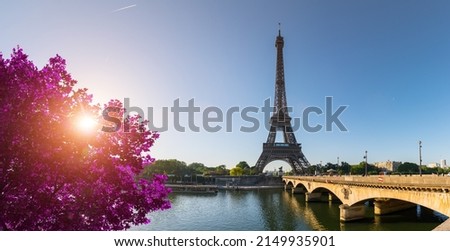 small paris street with view on the famous paris eiffel tower on a sunny day with some sunshine Royalty-Free Stock Photo #2149935901