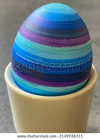 blue striped easter egg in eggcup