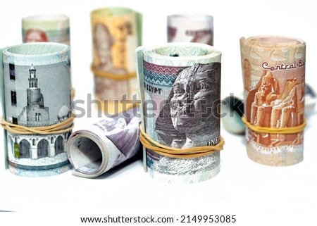 Egypt money roll pounds banknotes isolated on white background, Egyptian pounds cash money bills rolled up with rubber bands of 200 LE, 100, 50, 20, 10, 5, 1 pound and 50 piasters, selective focus Royalty-Free Stock Photo #2149953085
