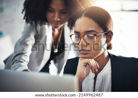 They add careful thought to every move they make. Shot of two businesswomen working together on a laptop in an office. Royalty-Free Stock Photo #2149962487