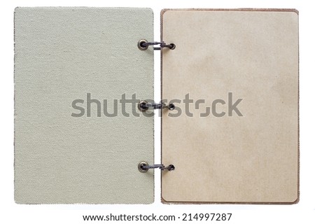 open notebook on a white background with a textile cover and with paper pages