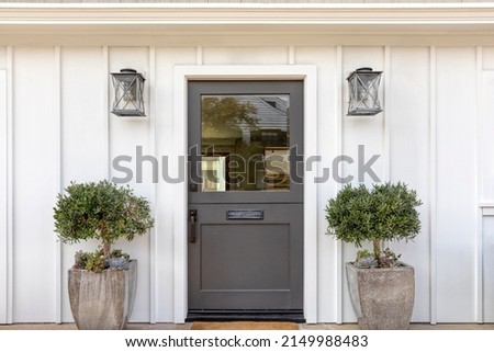 Dark gray front door of classic style home. Royalty-Free Stock Photo #2149988483