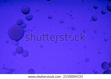 Abstract macro shot of oil drops on water. 