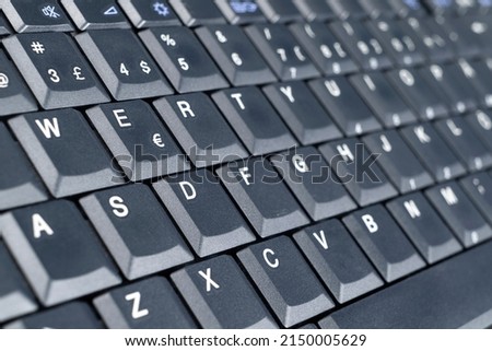 Closeup of a modern computer keyboard keys. Close up view of a business workplace with wireless computer keyboard. Top view