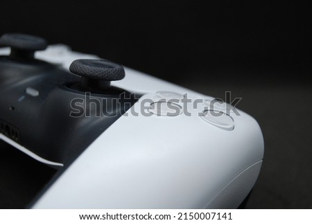 White next gen game controller, black background