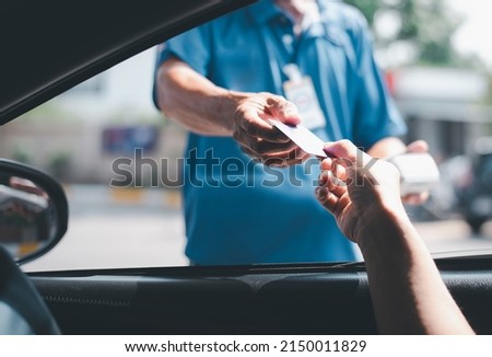Young Asian 
 man driving car hand holding credit card payment for gasoline at petrol station. Traveler man car owner paying fuel pump with credit card, customer mileage point loyalty reward concept. Royalty-Free Stock Photo #2150011829
