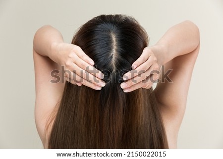 A woman is massaging her scalp. Royalty-Free Stock Photo #2150022015