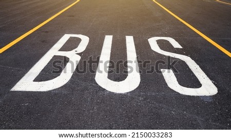 The perspective bus stop parking or bus lane is lined with black asphalt.