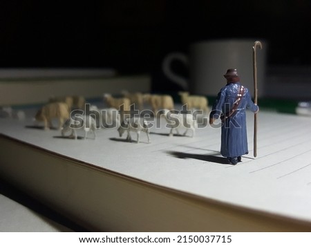 Miniature scene of shepherd. Conceptual design photography on the office desk. Unfocus view conceptual design. Blurred background.
