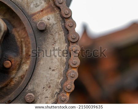 Gear, detail of an old combine. Rusty metal gear with chain. Royalty-Free Stock Photo #2150039635